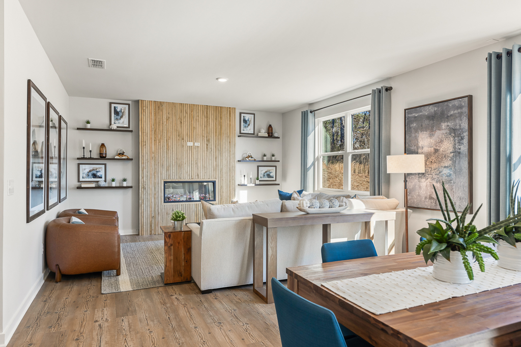 A living room with a table and chairs.
