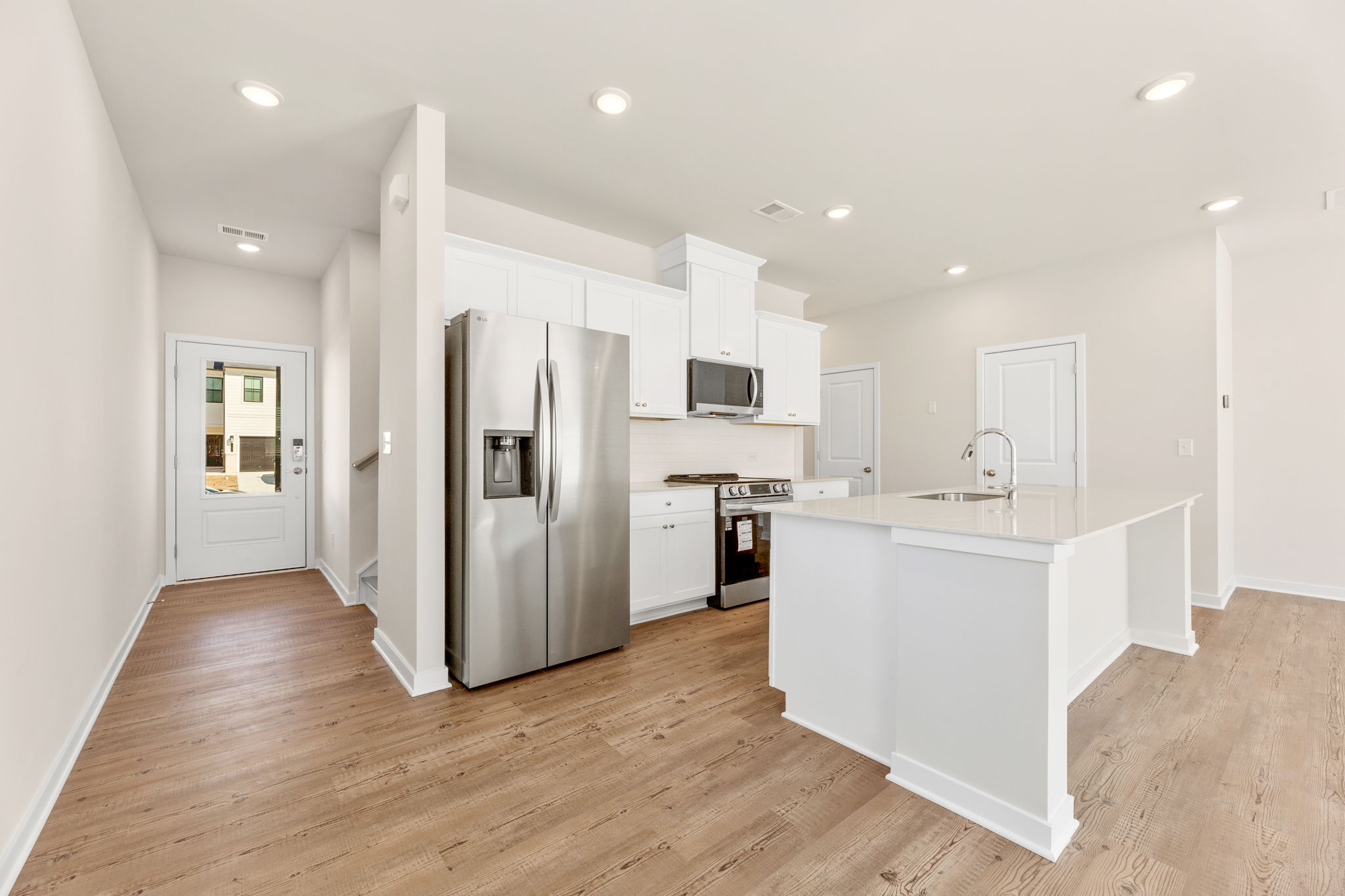 A kitchen with white cabinets.