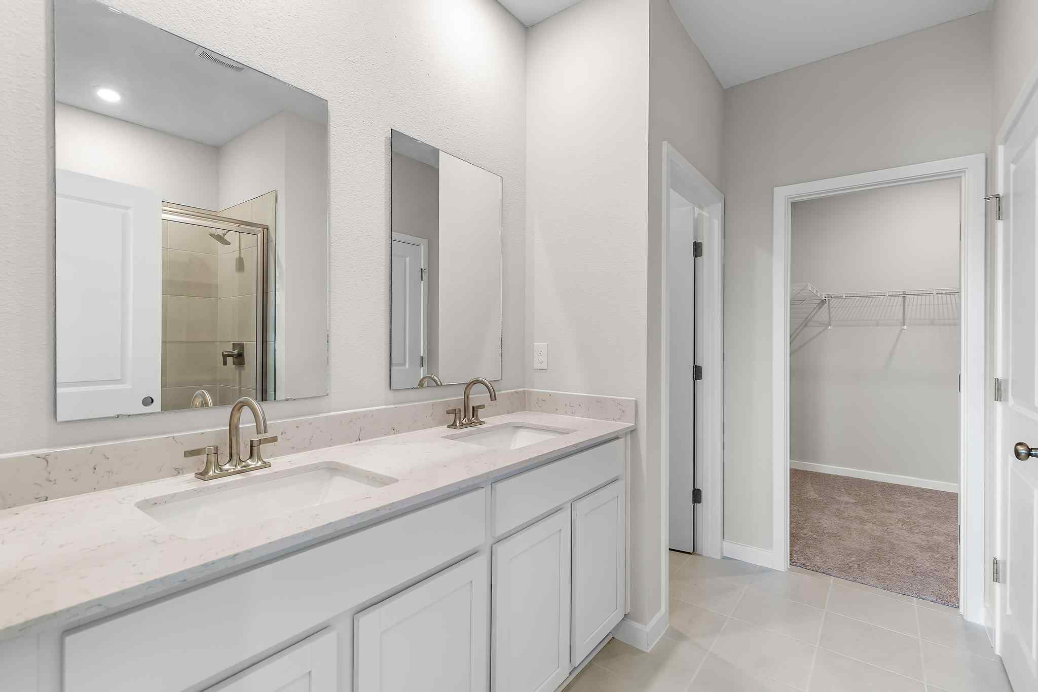 A bathroom with a sink and a shower.