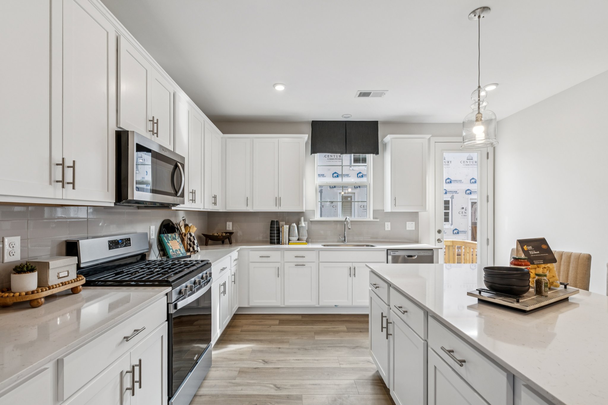 A kitchen with white cabinets.