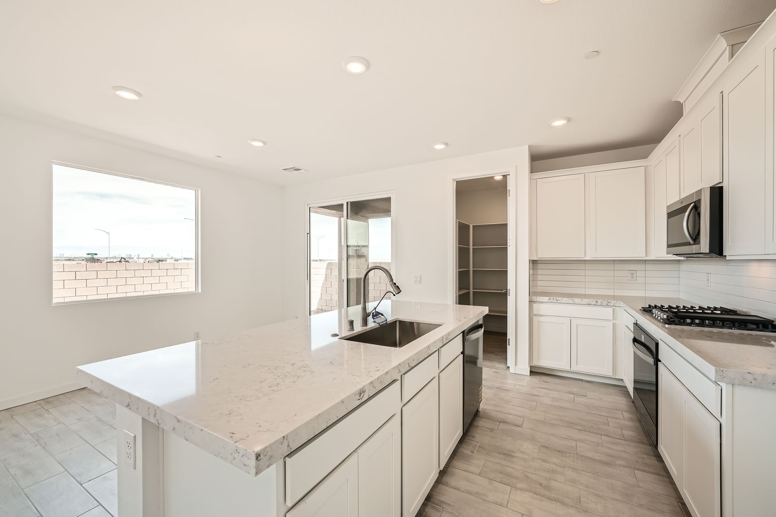 A kitchen with white cabinets.