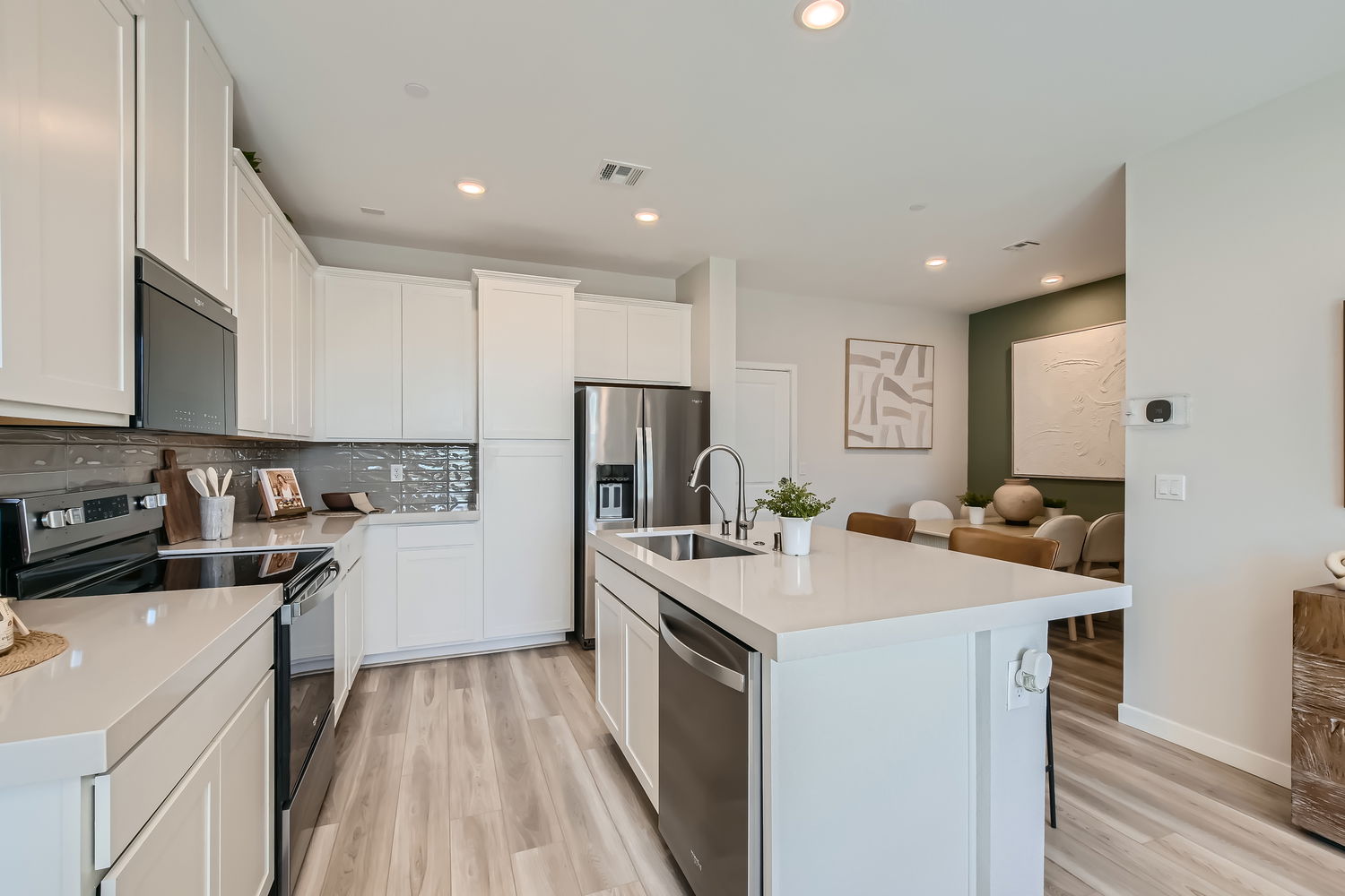 A kitchen with white cabinets.