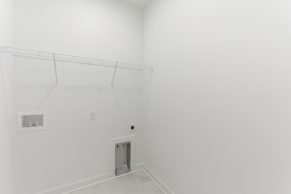 A white wall with a vent.