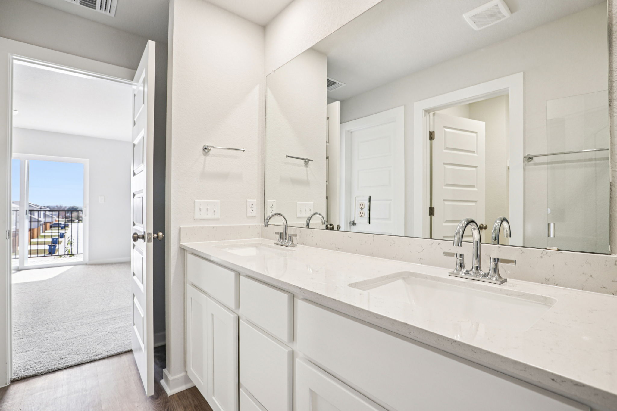 A bathroom with white cabinets.