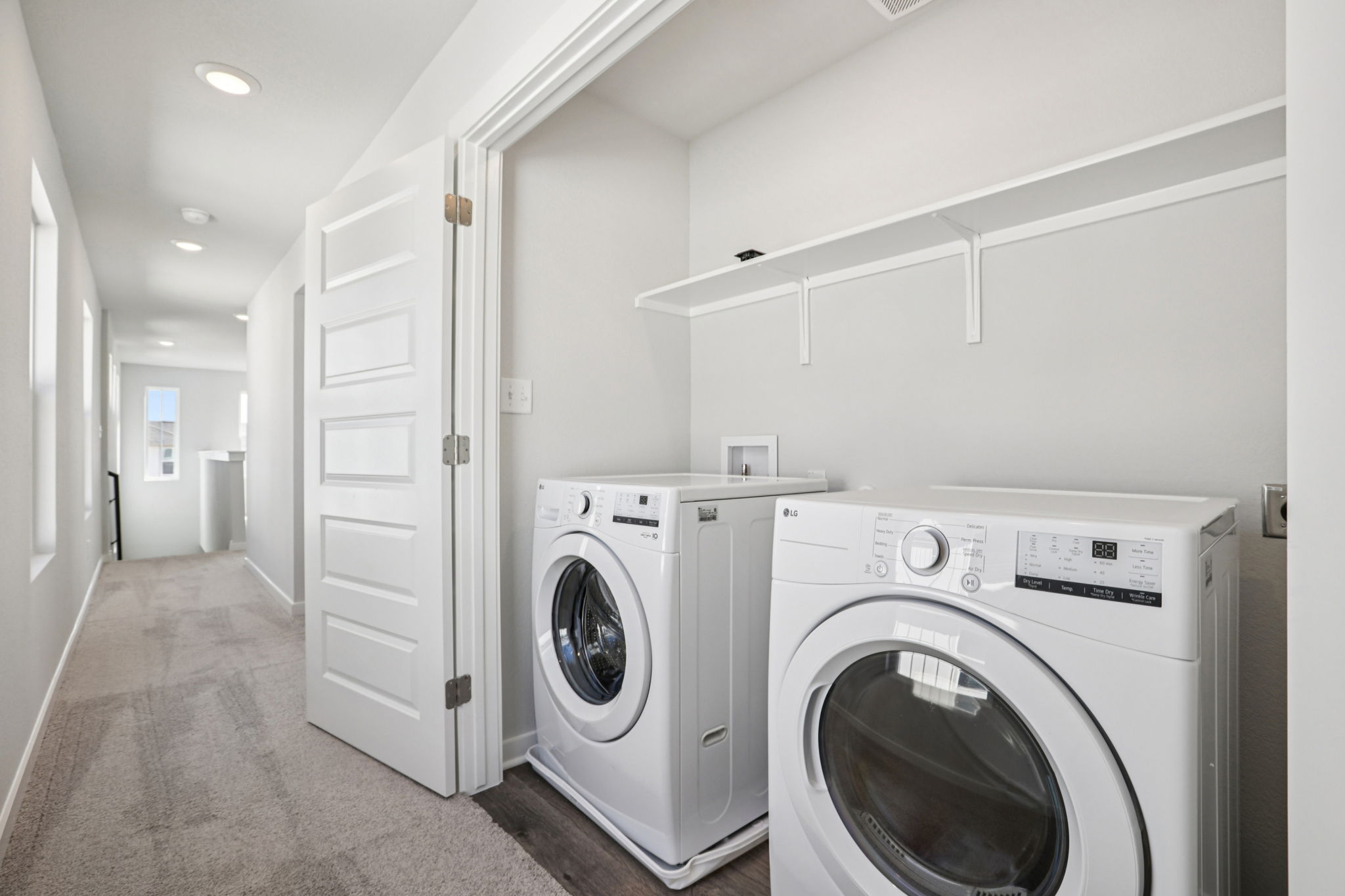 A room with a washing machine and dryer.