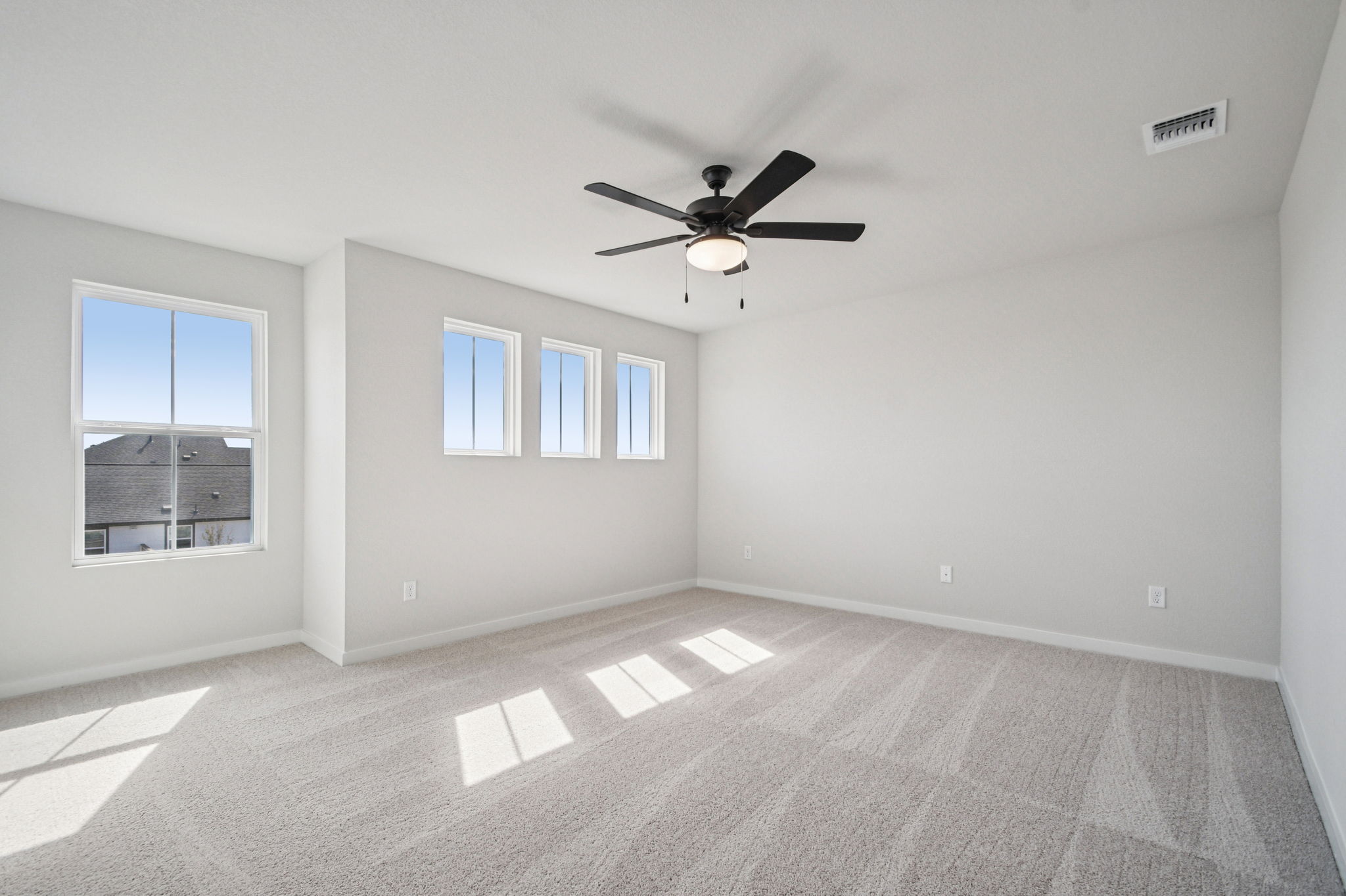 A room with a ceiling fan and a window.