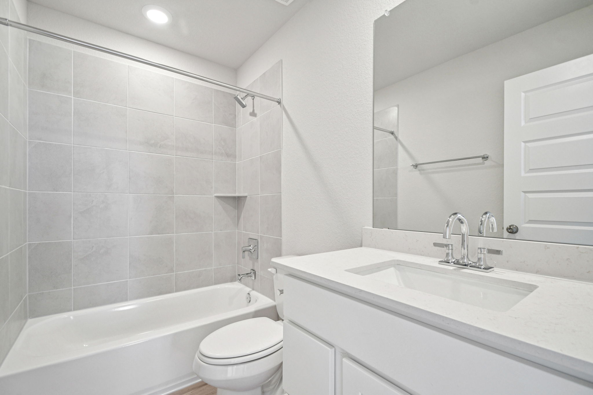 A bathroom with a tub sink and toilet.
