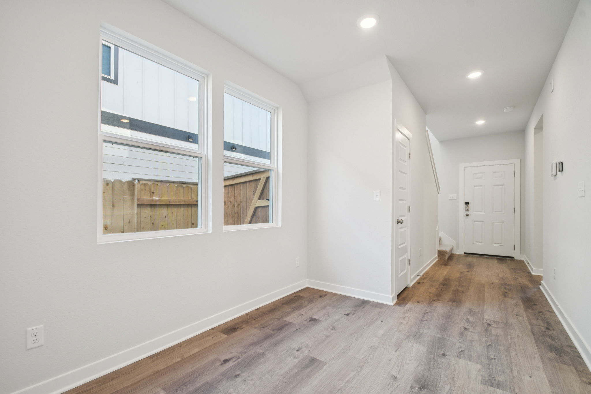 A room with white walls and a wood floor.