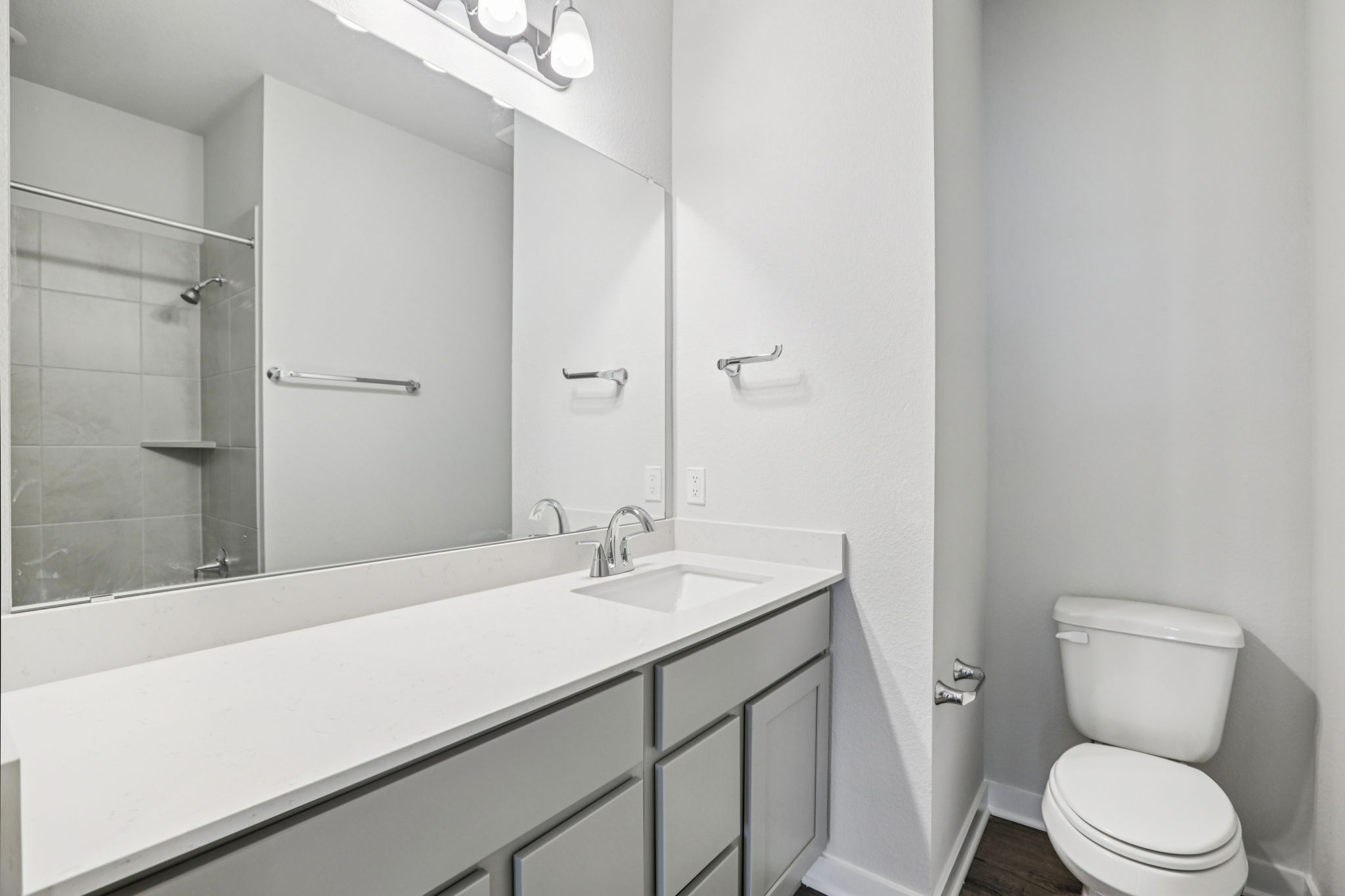 A bathroom with a tub sink and toilet.