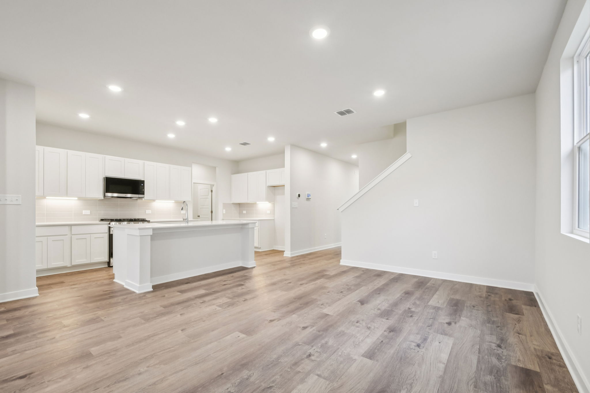 A large kitchen with white cabinets.
