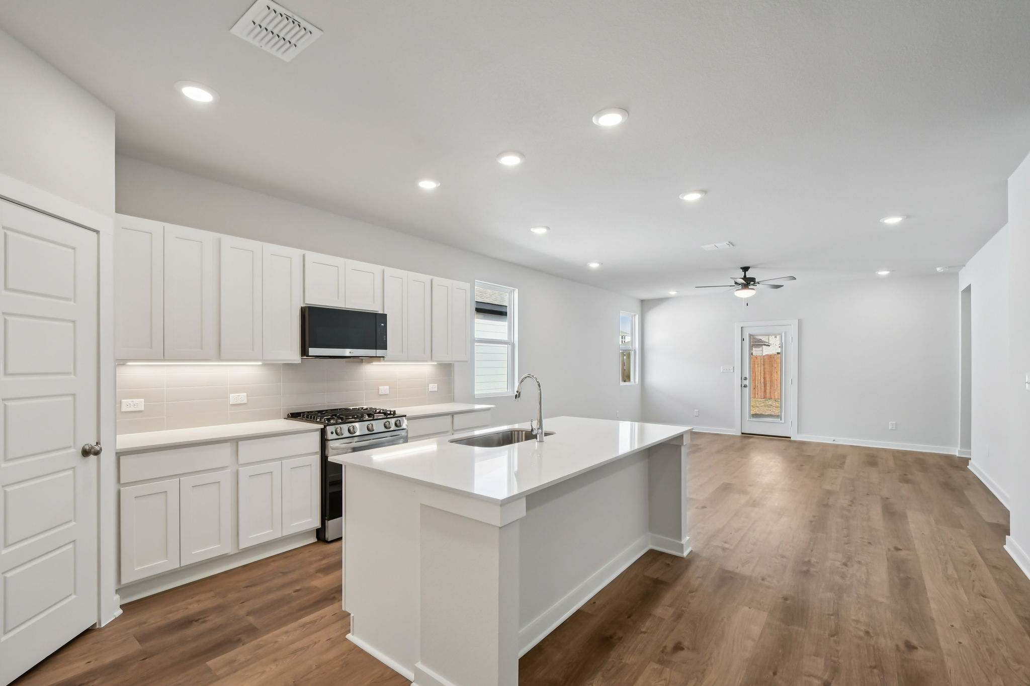 A kitchen with white cabinets.