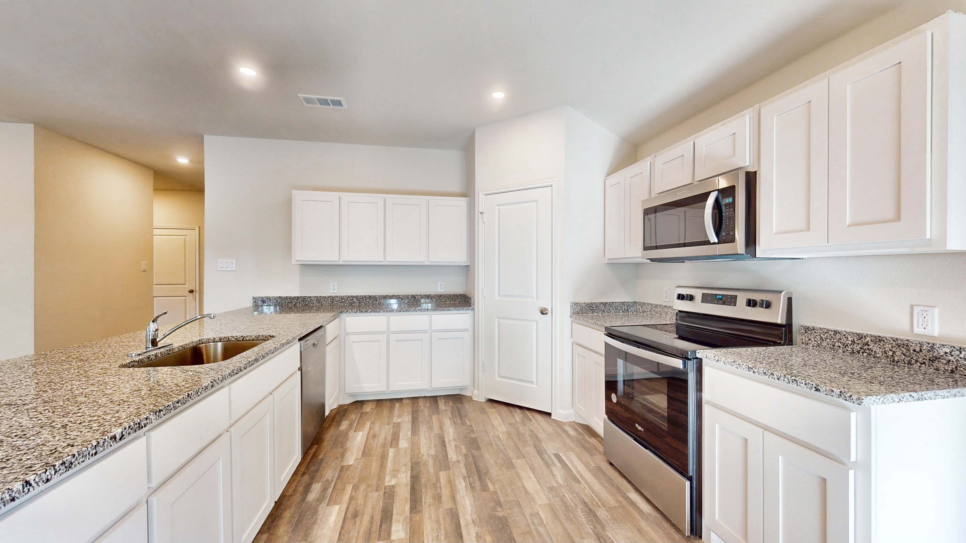 A kitchen with white cabinets.