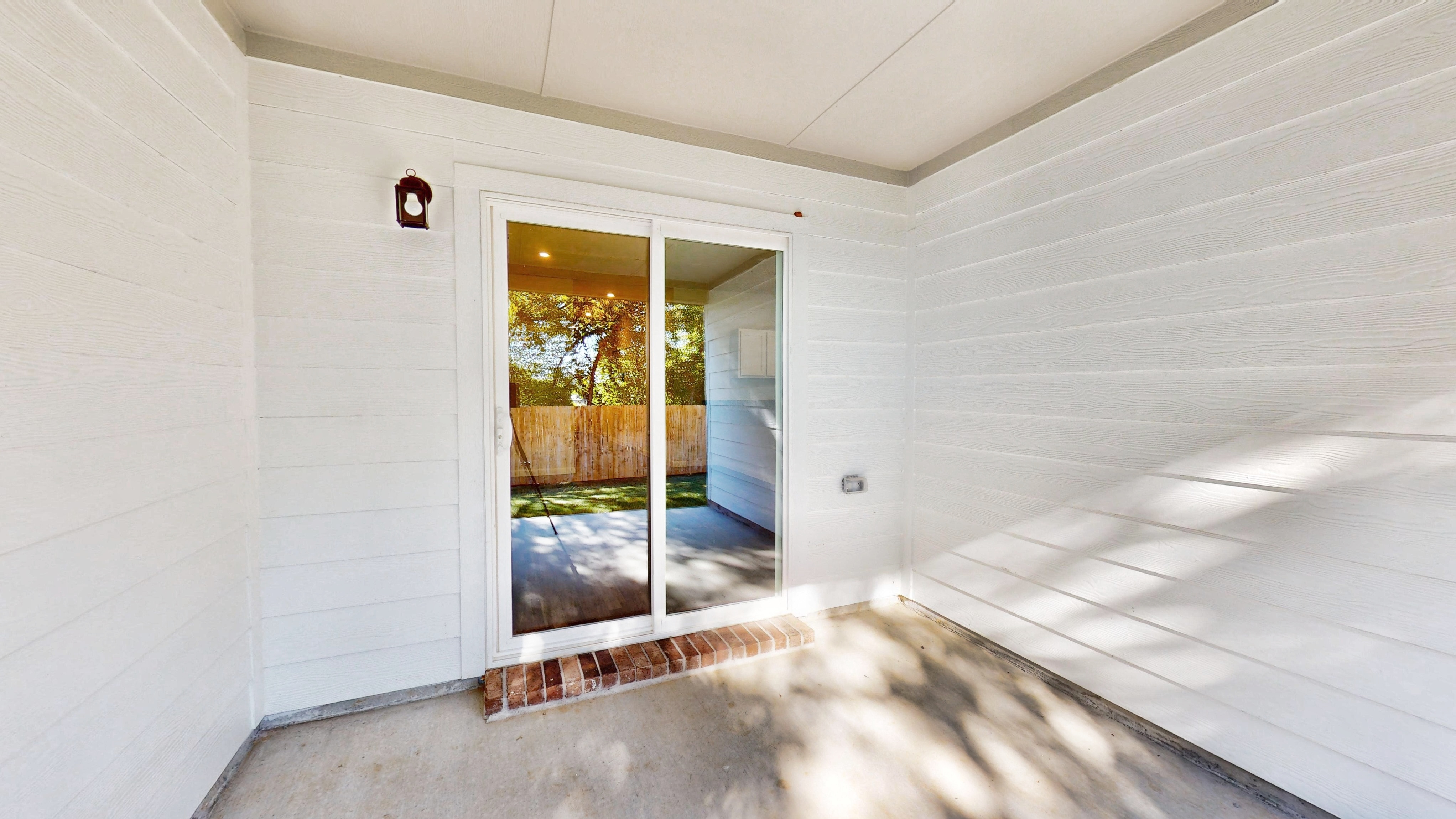 A hallway with a glass door.