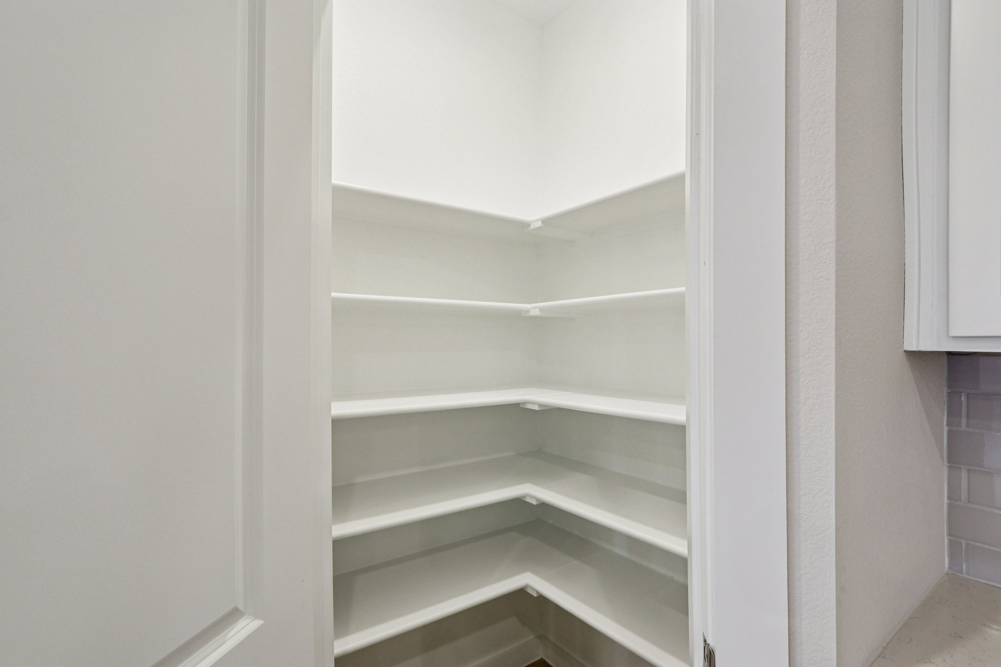 A white shelf in a room.