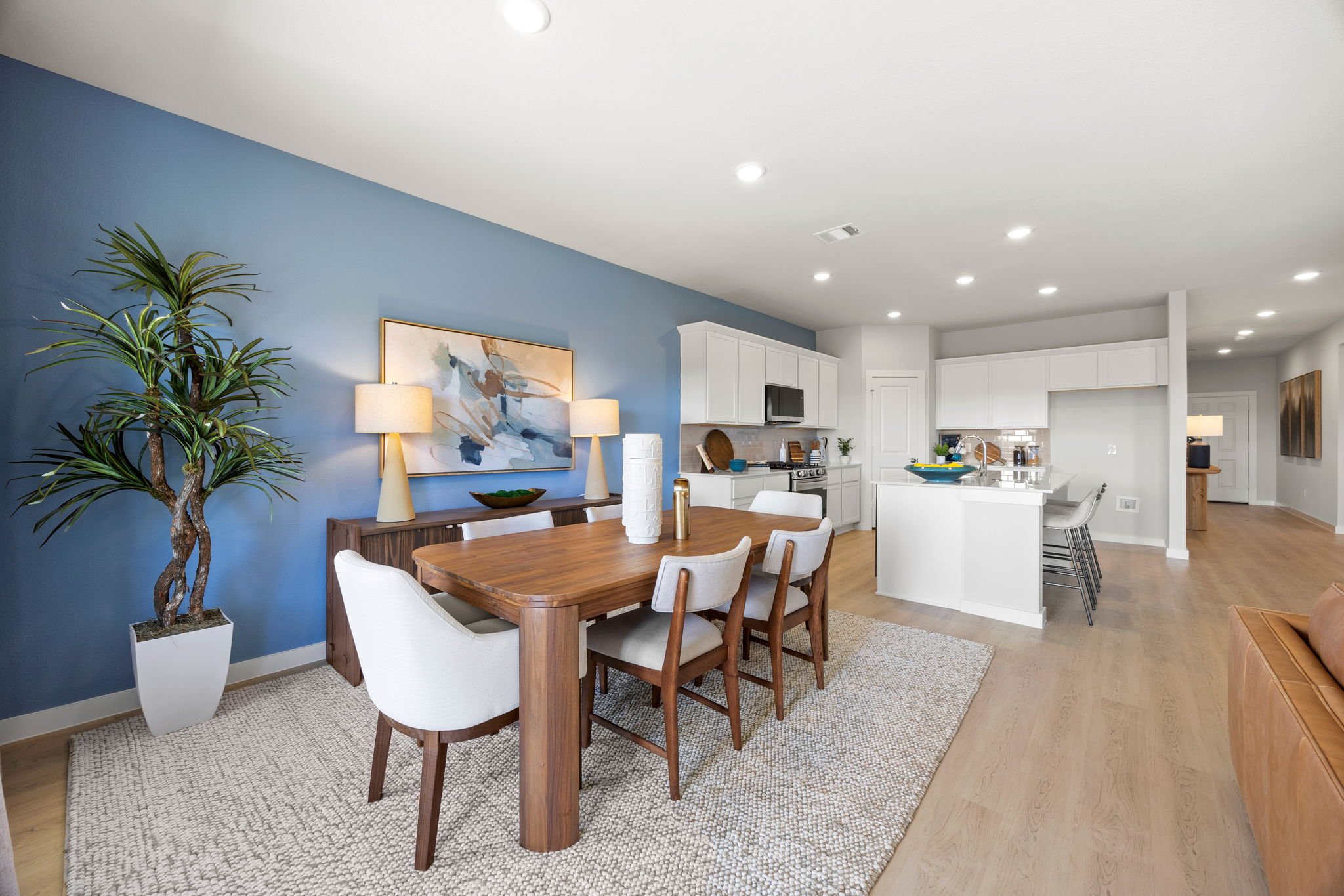 A dining room with a table and chairs.
