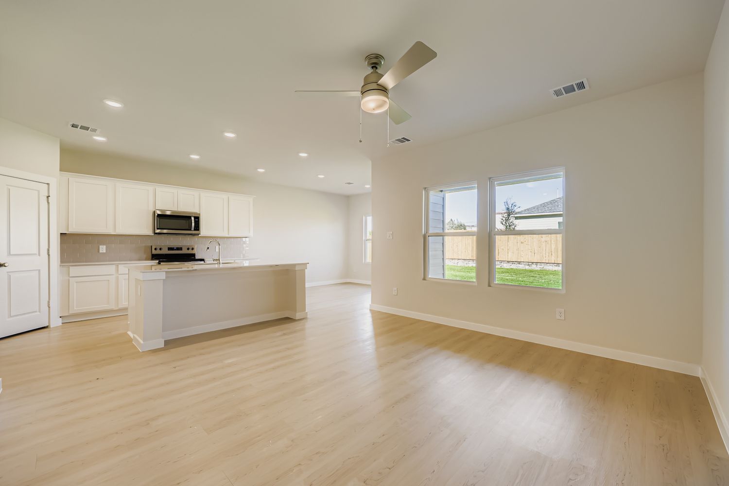 A kitchen with white cabinets.