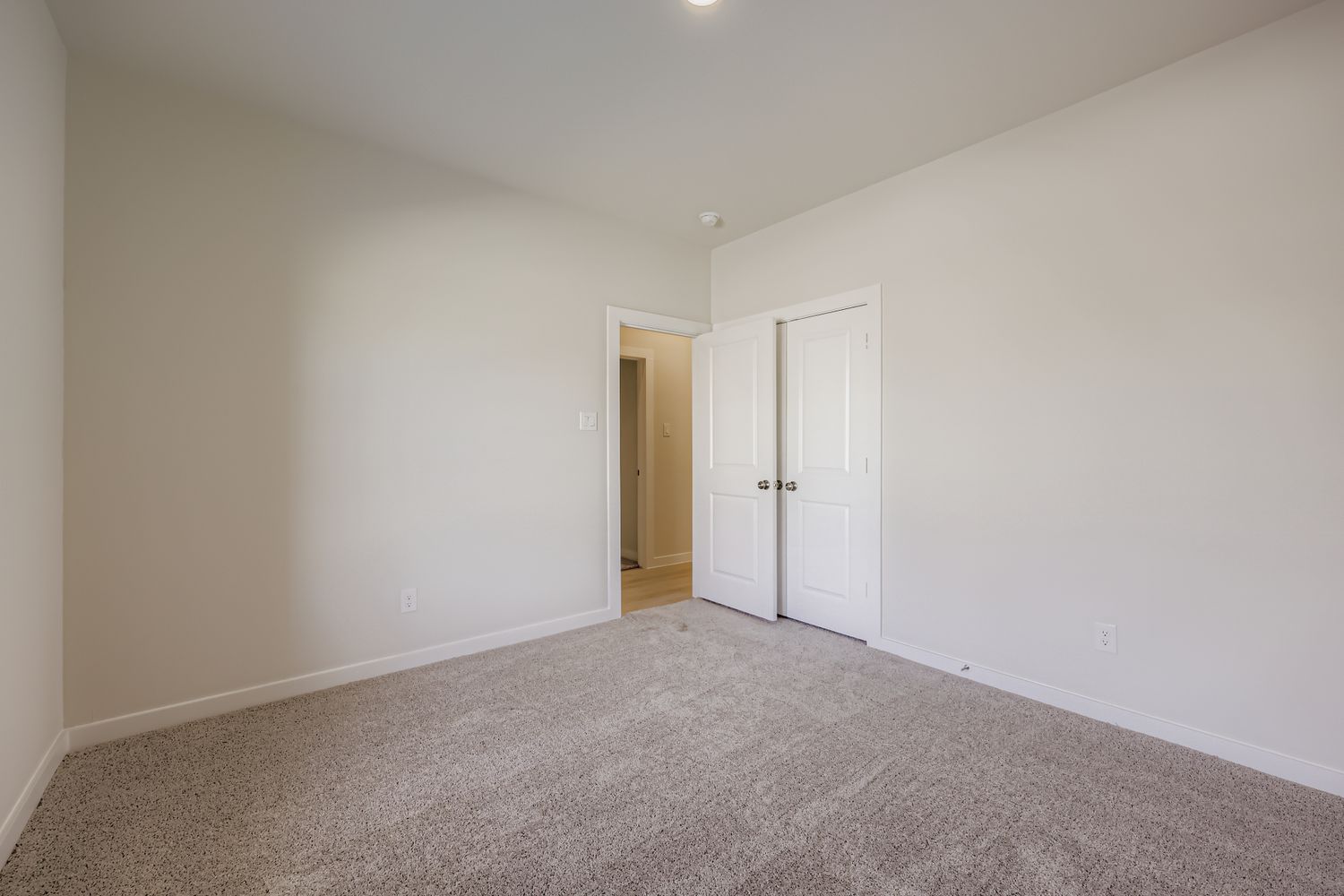 A hallway with white doors.