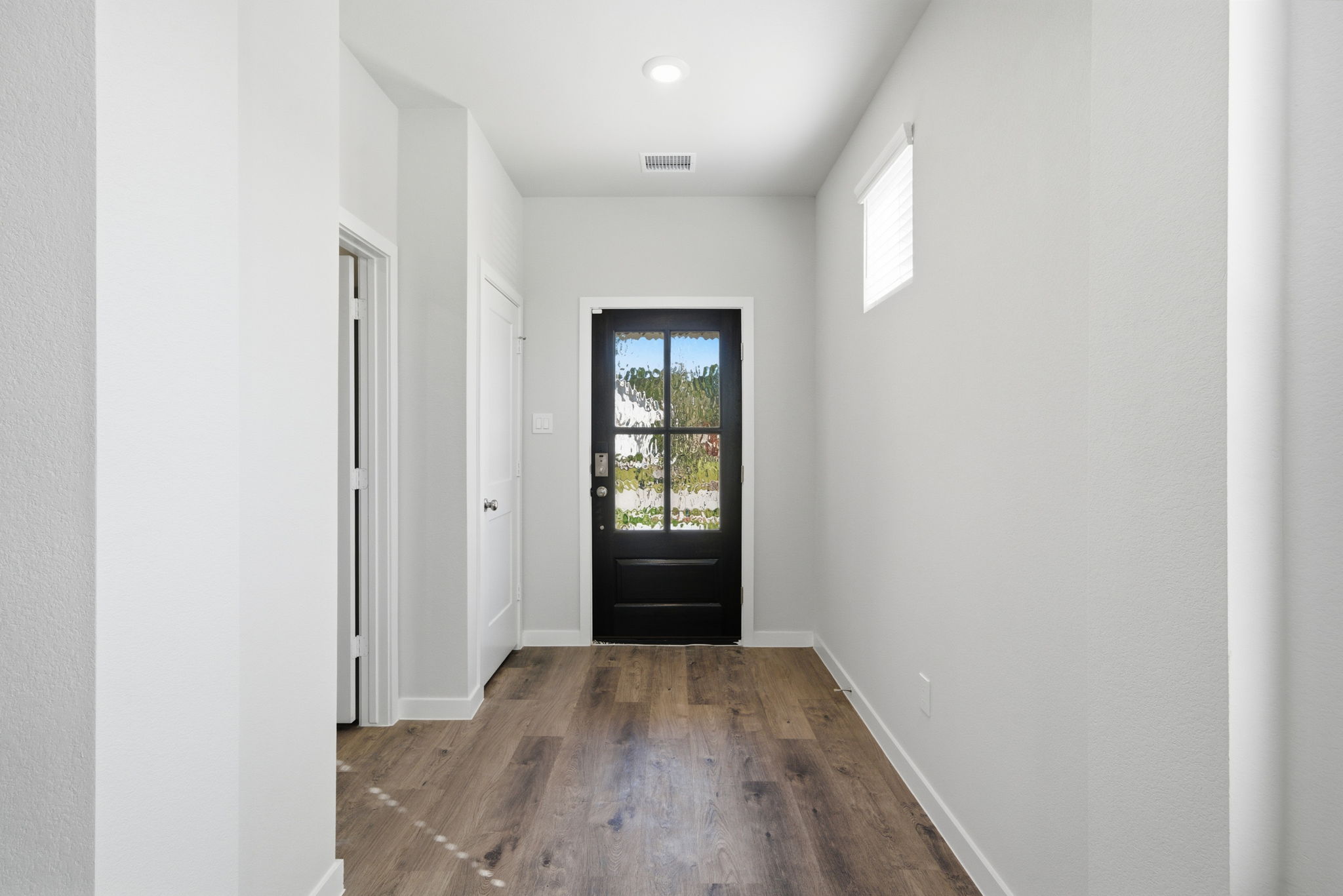 A hallway with white walls.