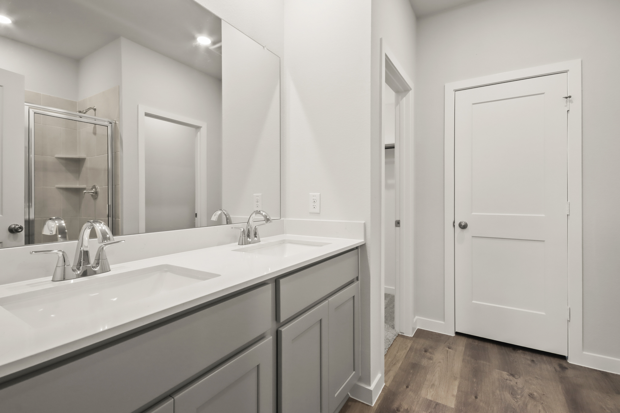 A bathroom with a large mirror.