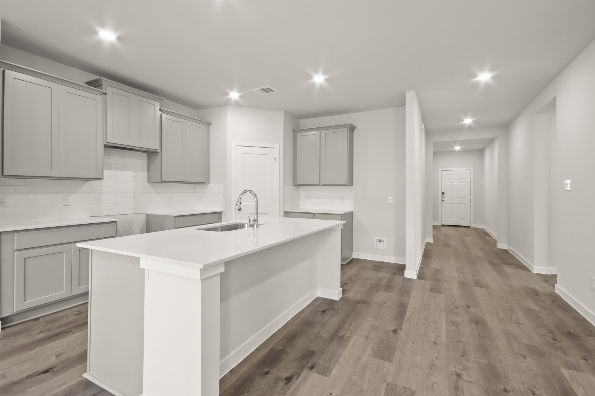 A kitchen with white cabinets.