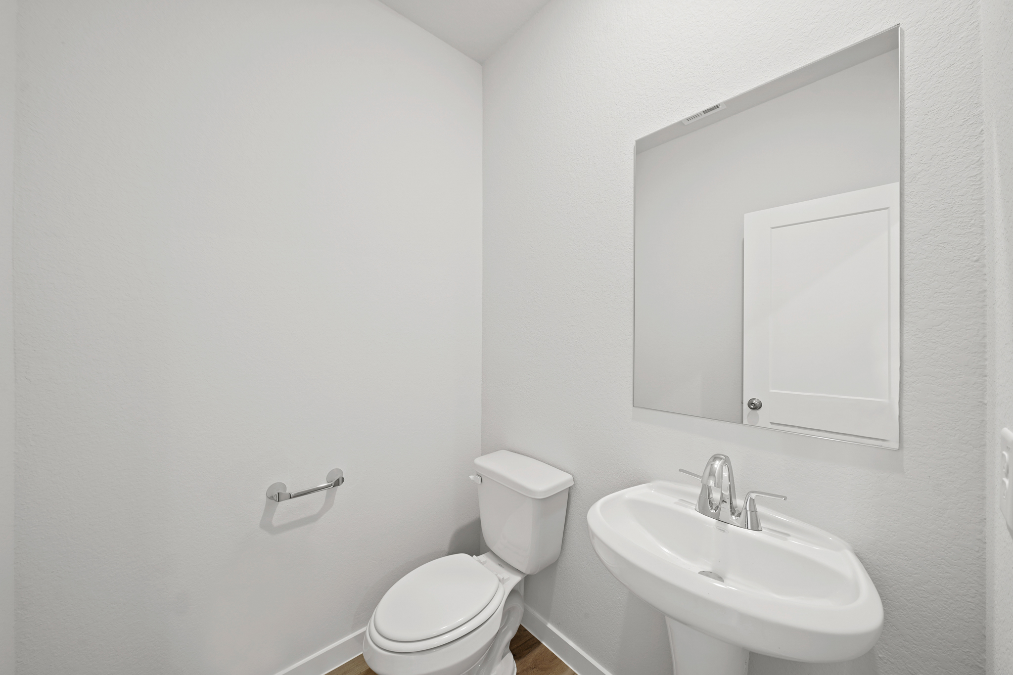 A bathroom with a toilet and sink.