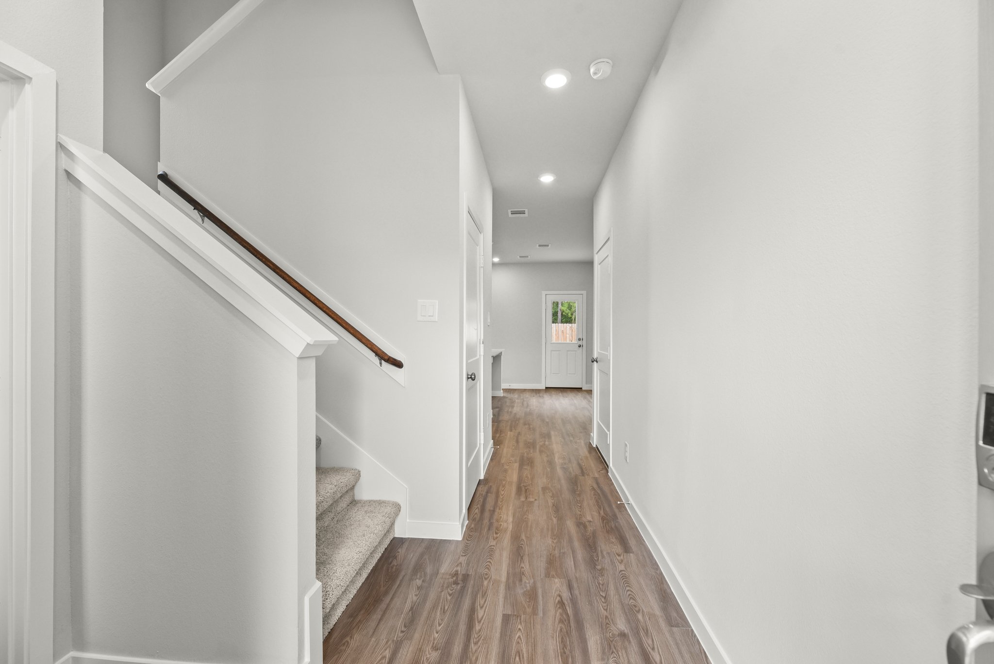 A hallway with white walls.