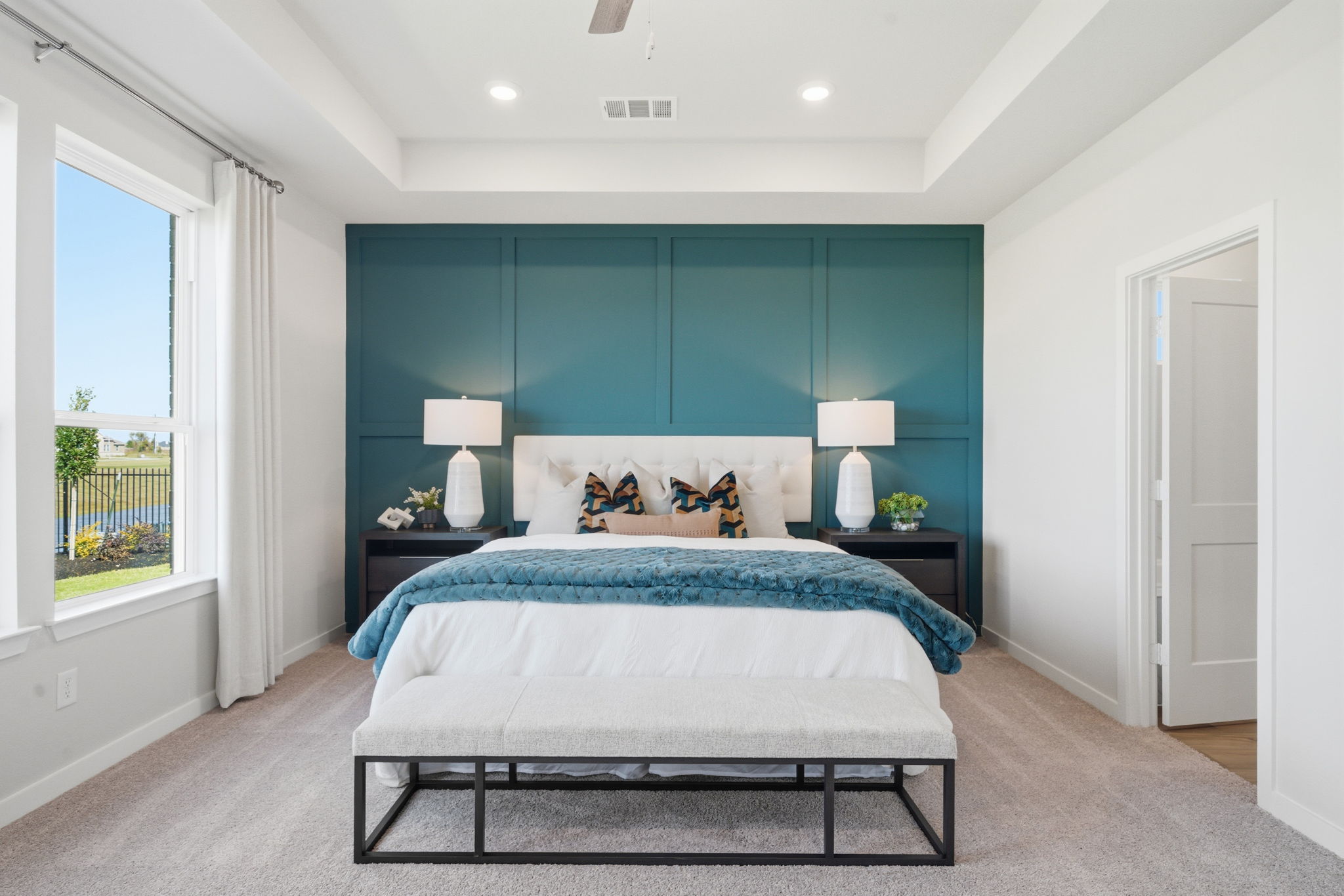 A bedroom with a bed and a table.