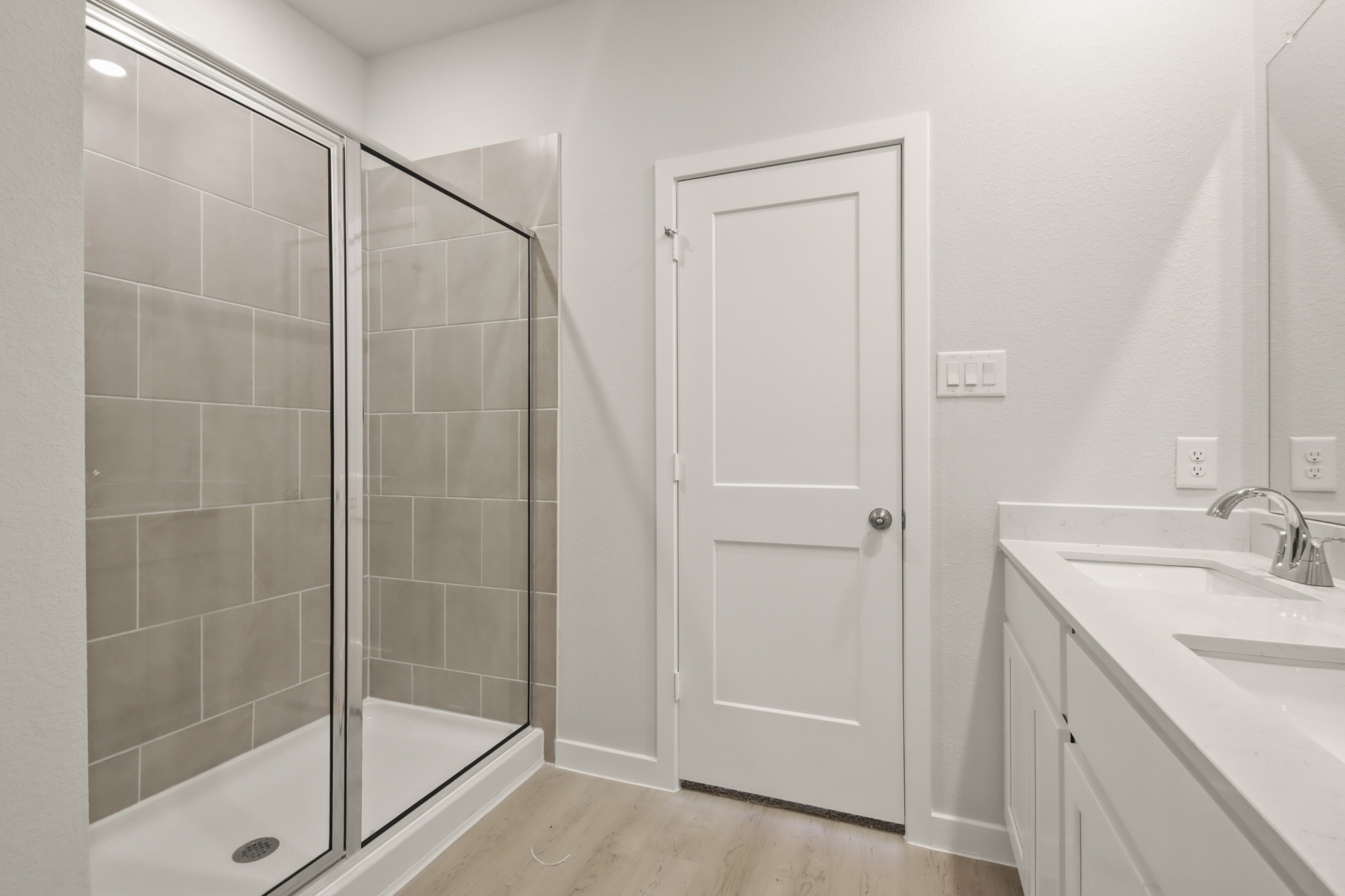 A bathroom with a glass shower.