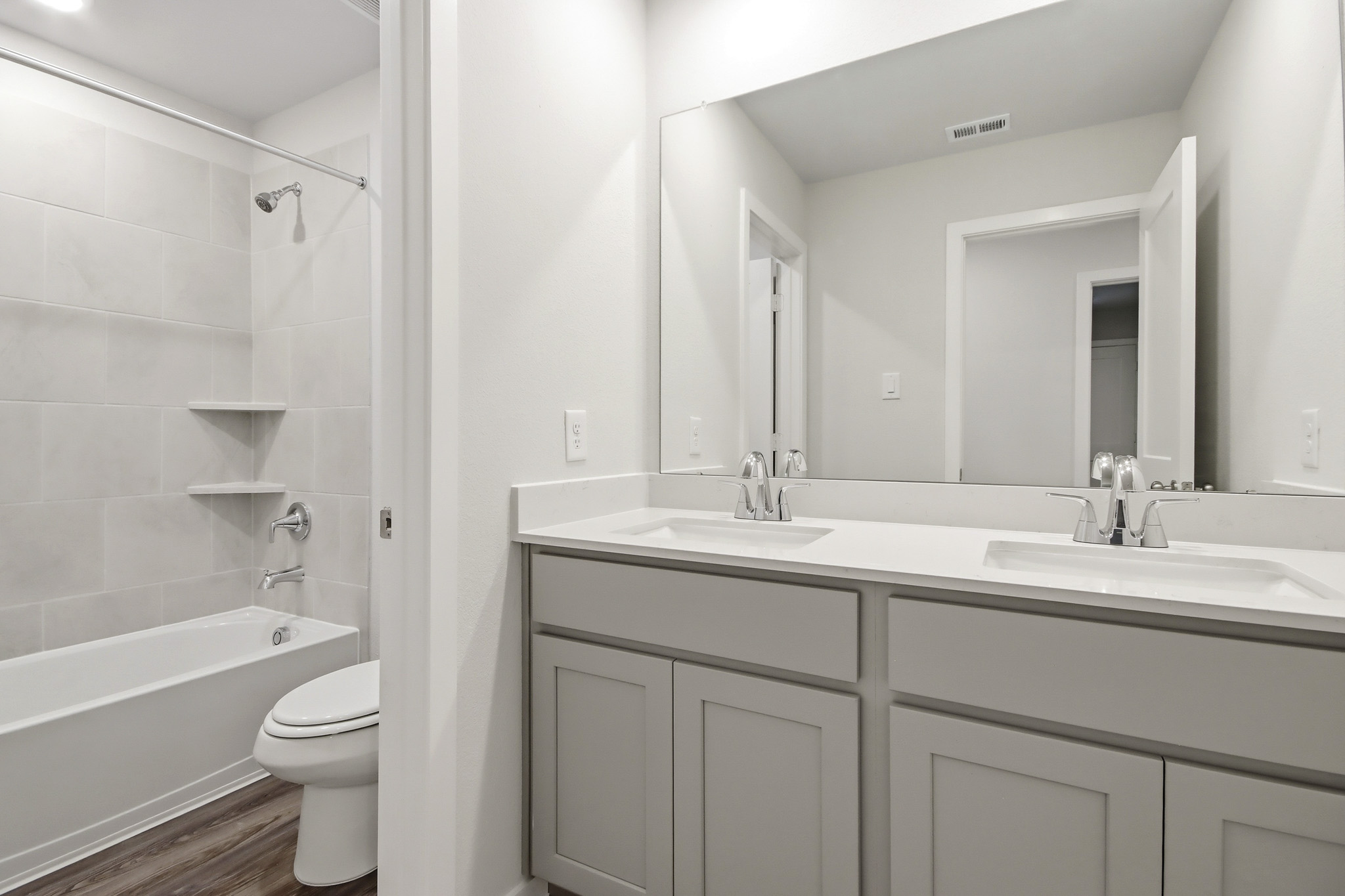 A bathroom with a tub sink and toilet.