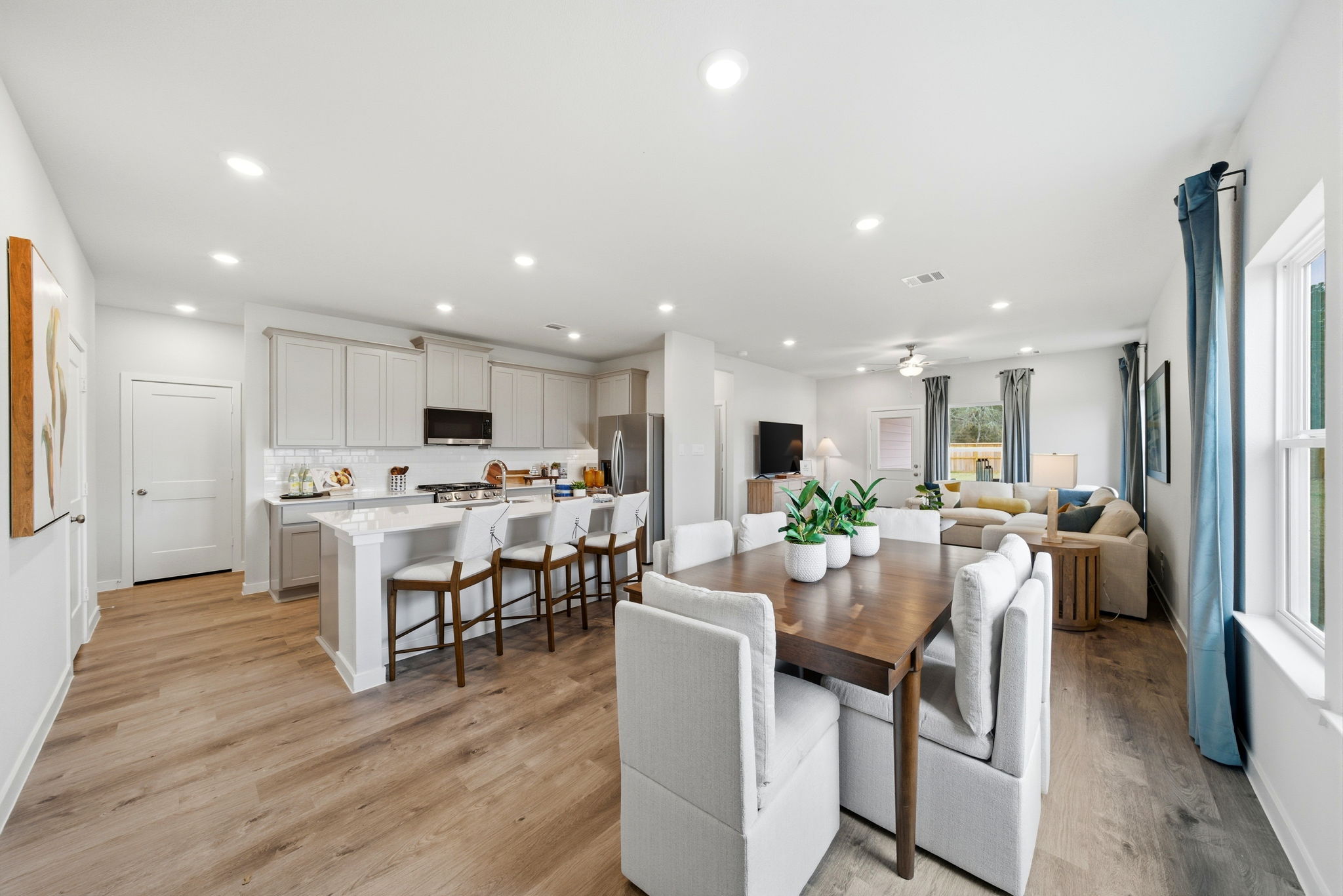 A large kitchen with a dining table.