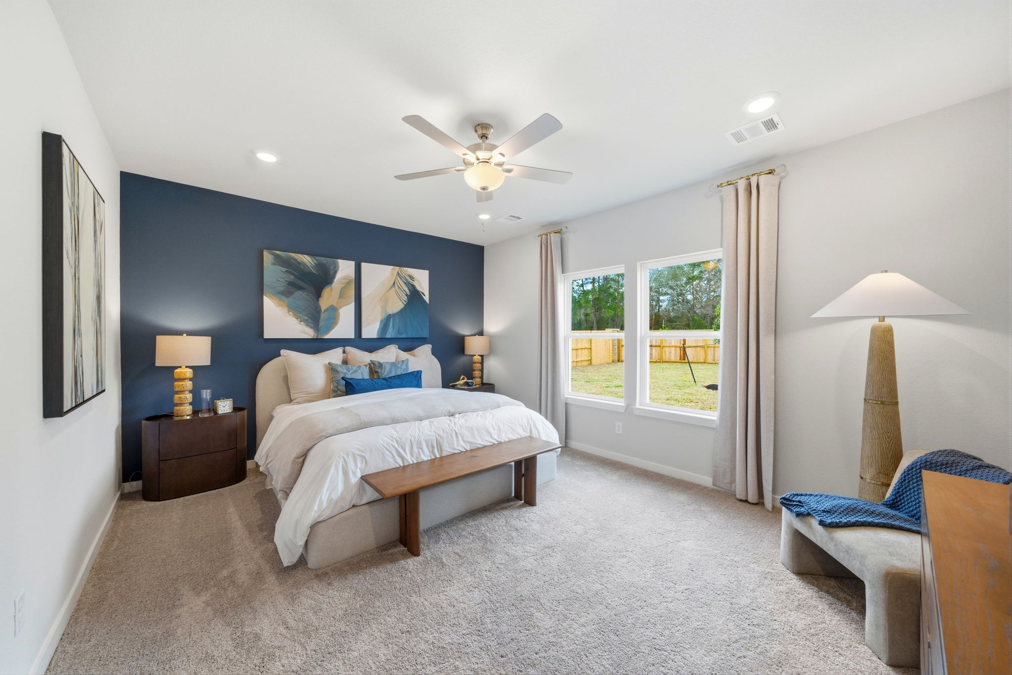 A bedroom with a large window.