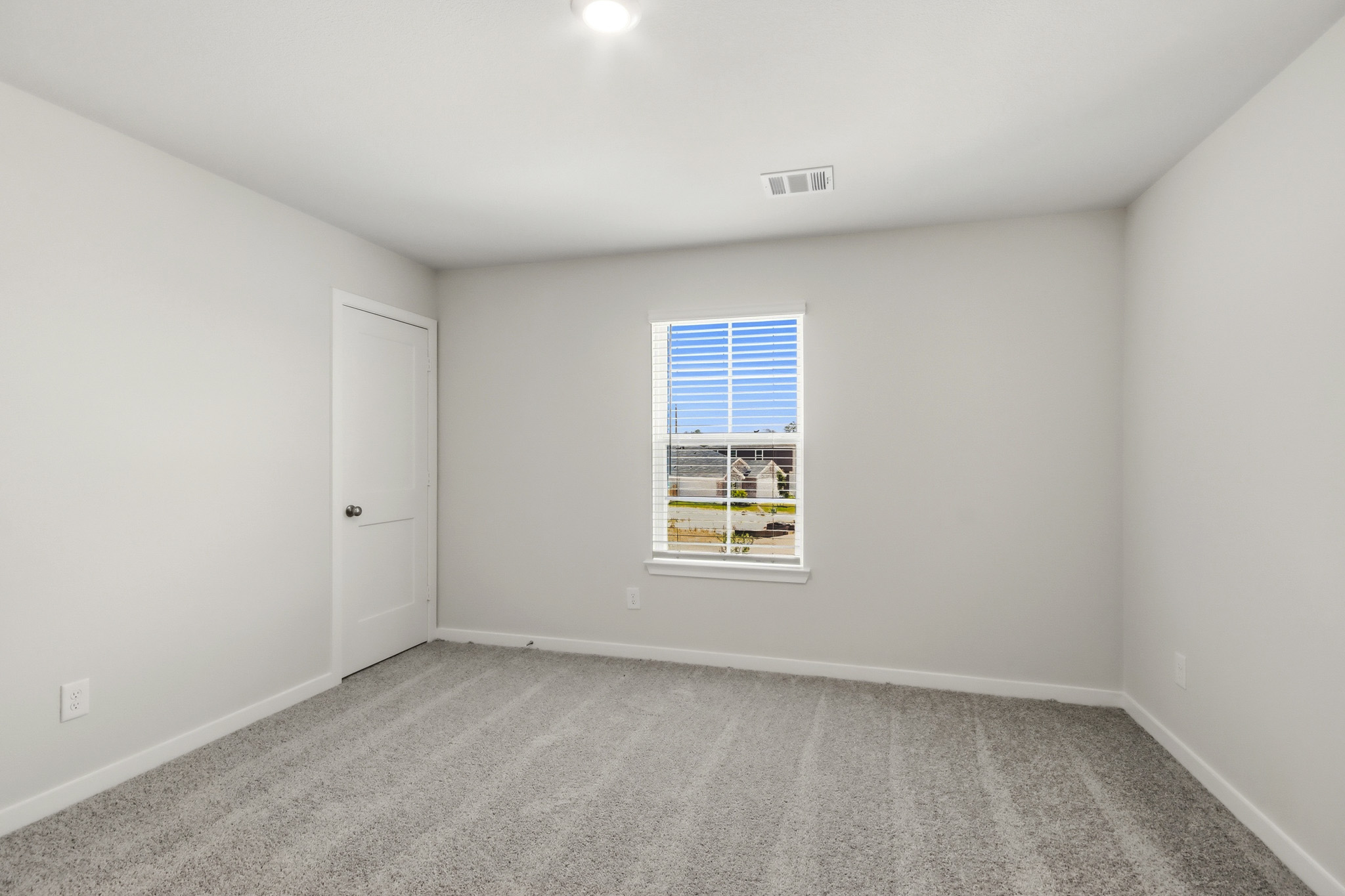A room with a window and a door.