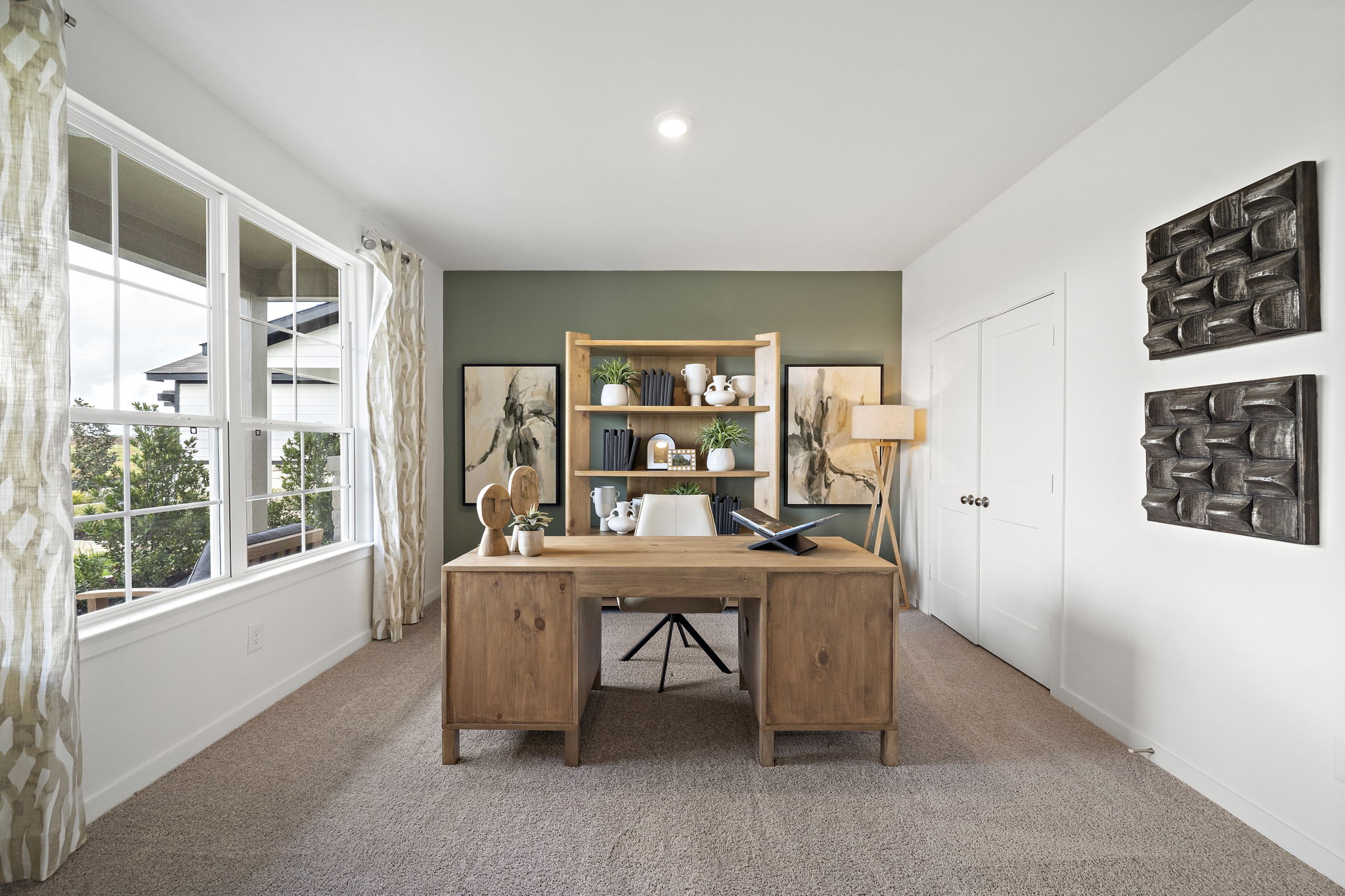 A room with a desk and a window.