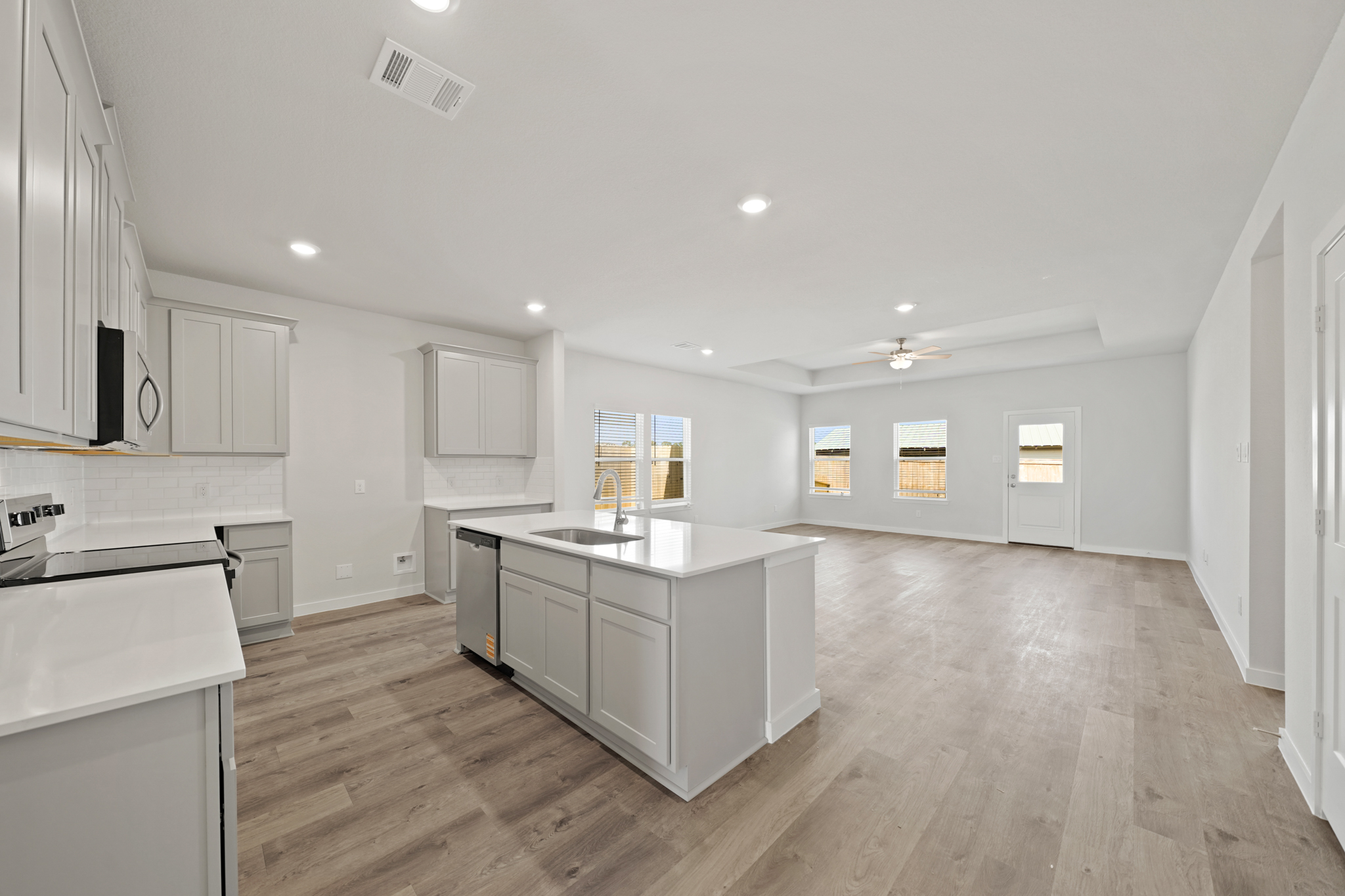 A large kitchen with white cabinets.