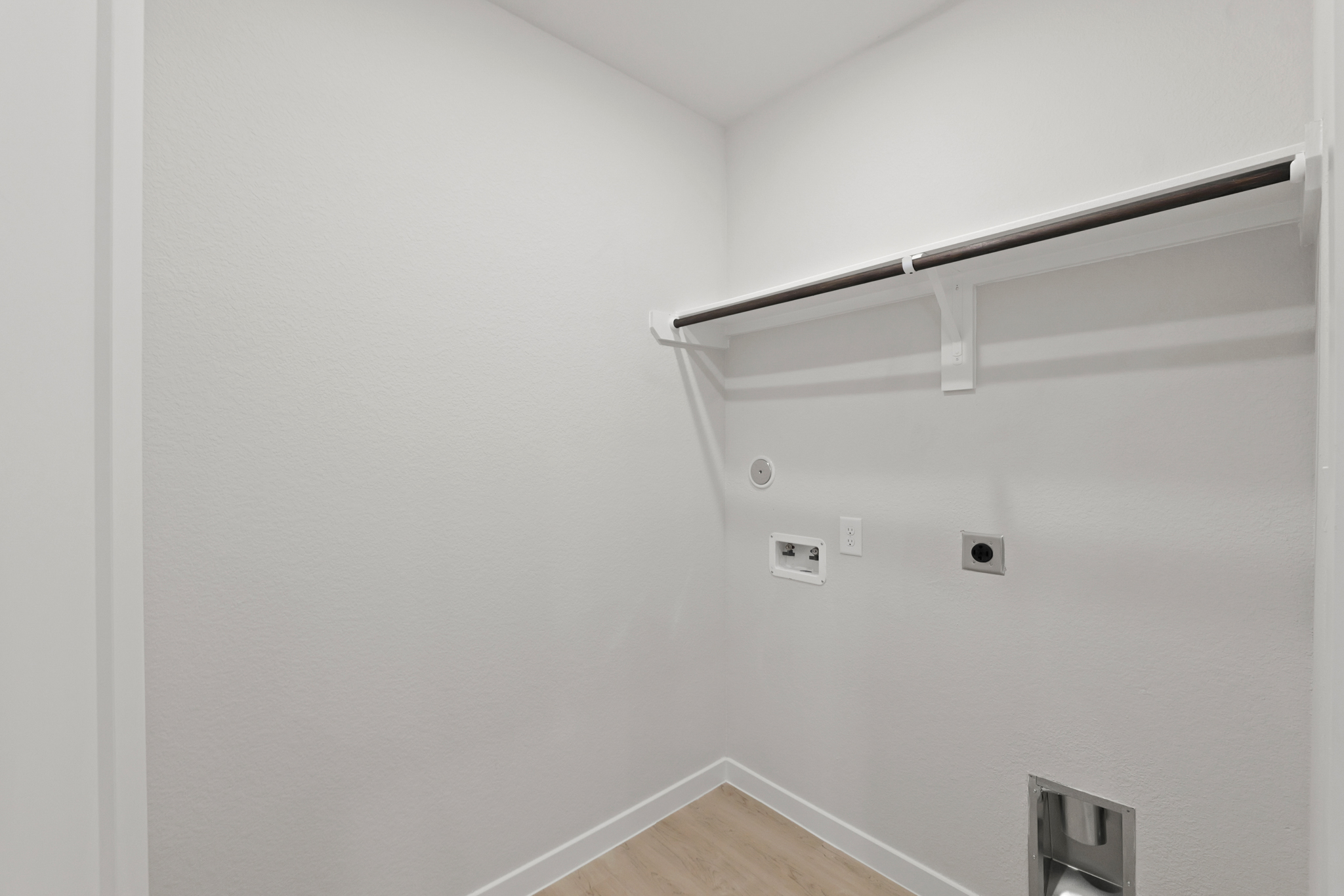 A white wall with a light fixture.