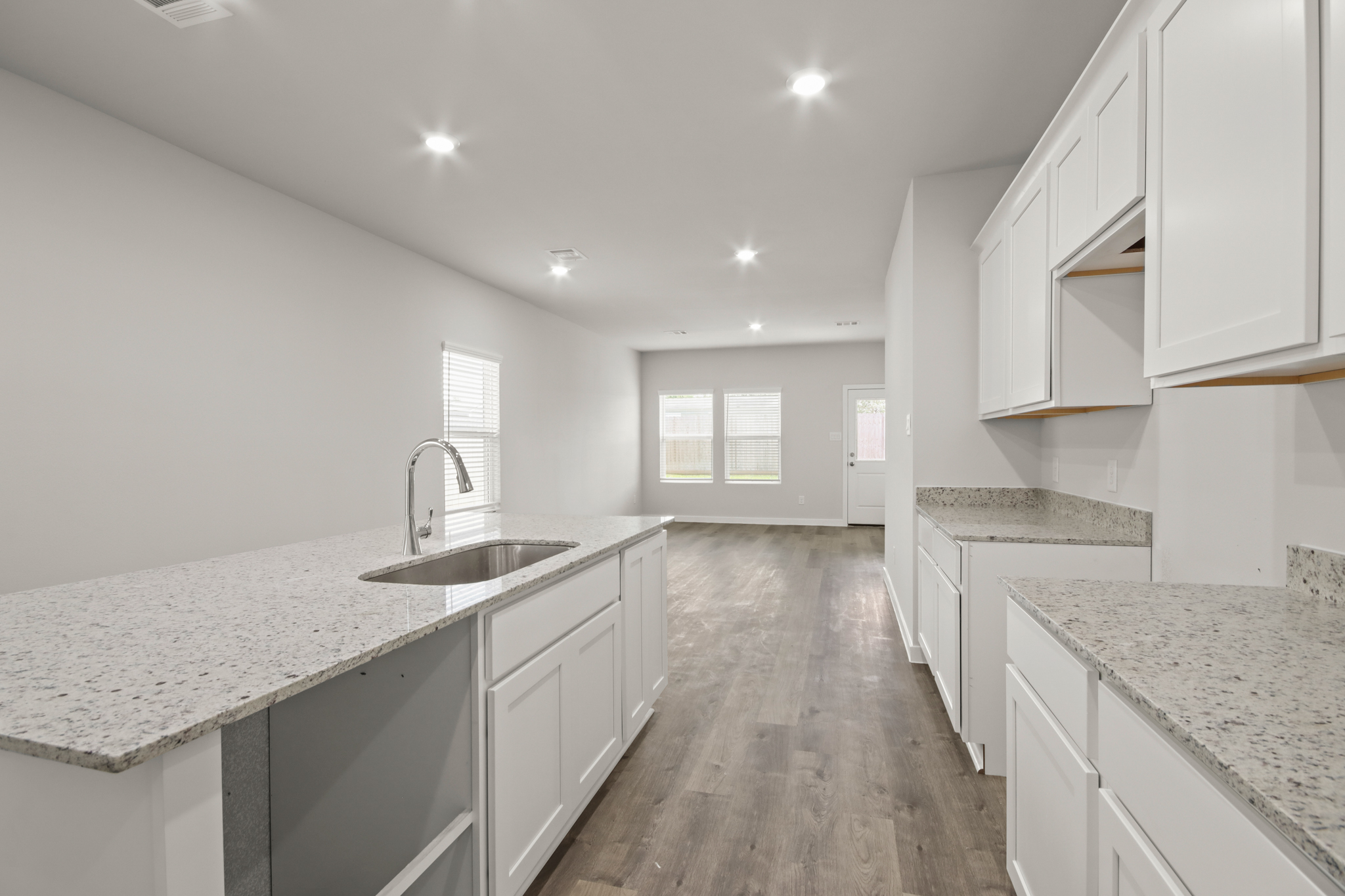 A kitchen with white cabinets.