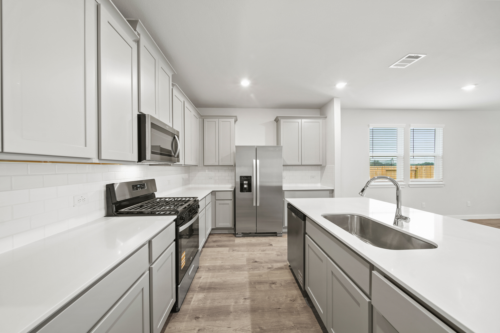 A kitchen with white cabinets.