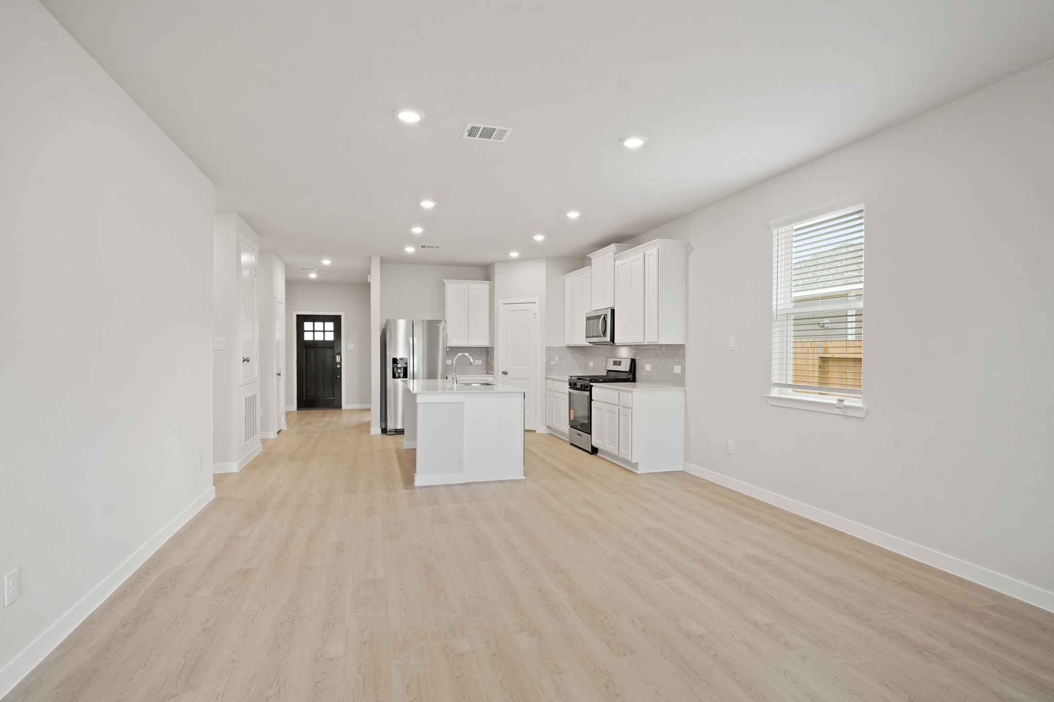 A kitchen with white cabinets.