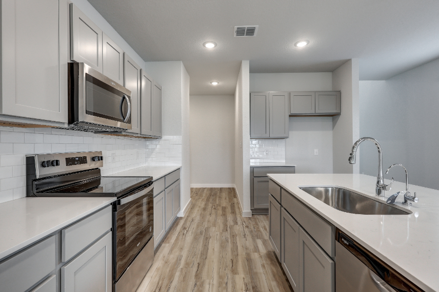 A kitchen with white cabinets.