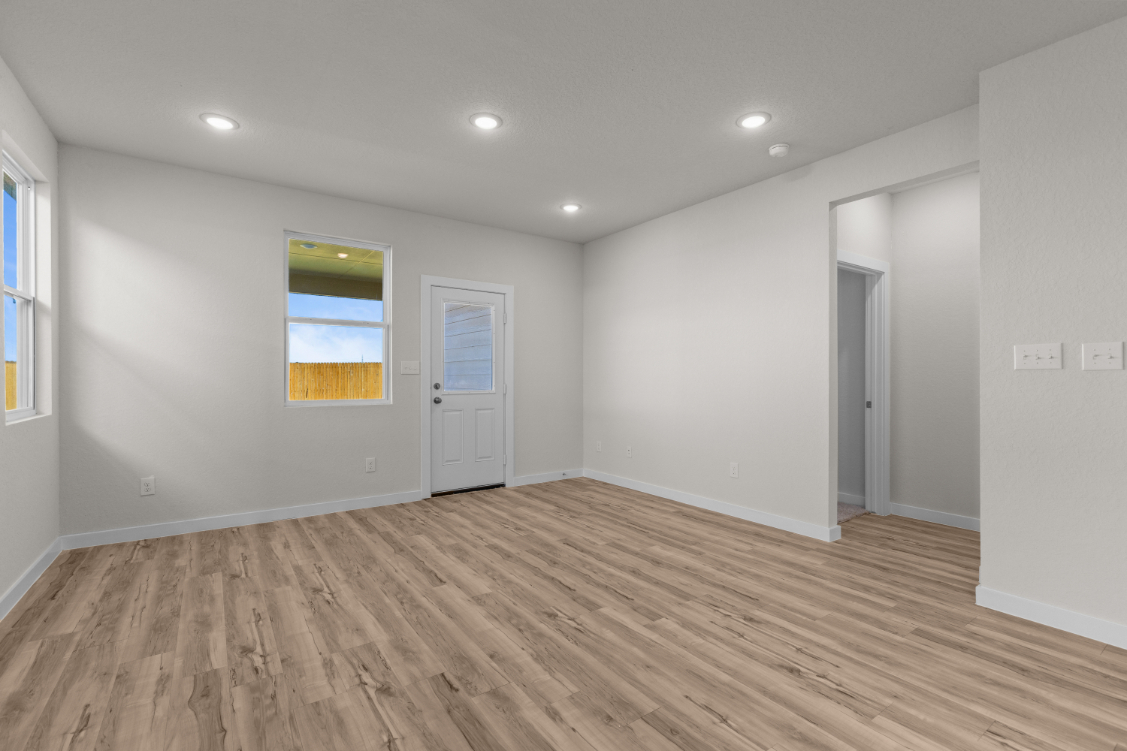 A room with a wood floor and white walls.