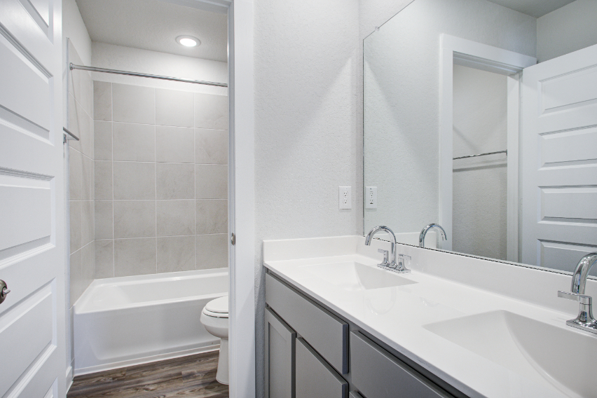 A bathroom with a tub sink and toilet.