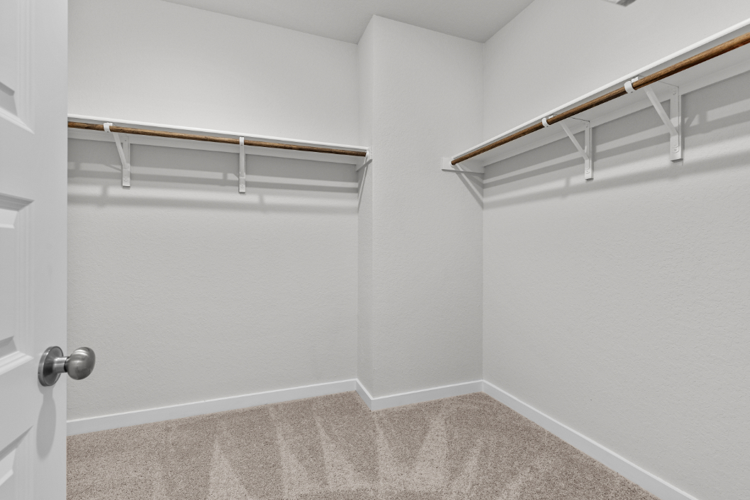 A white room with a metal railing.