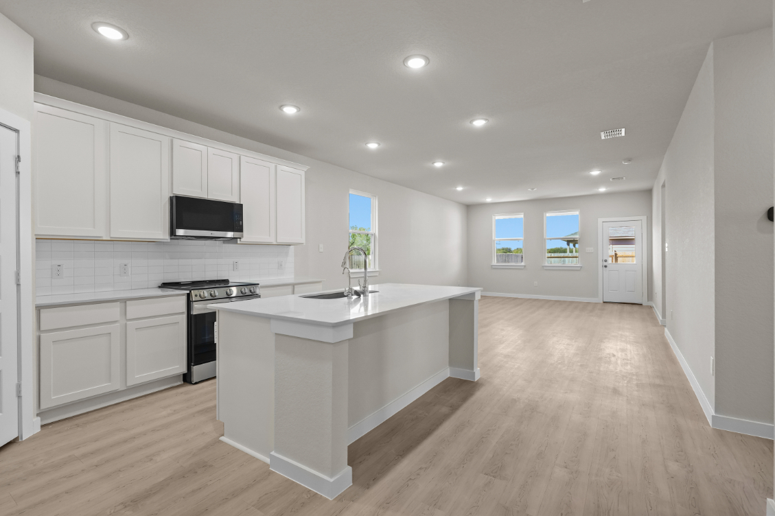 A kitchen with white cabinets.