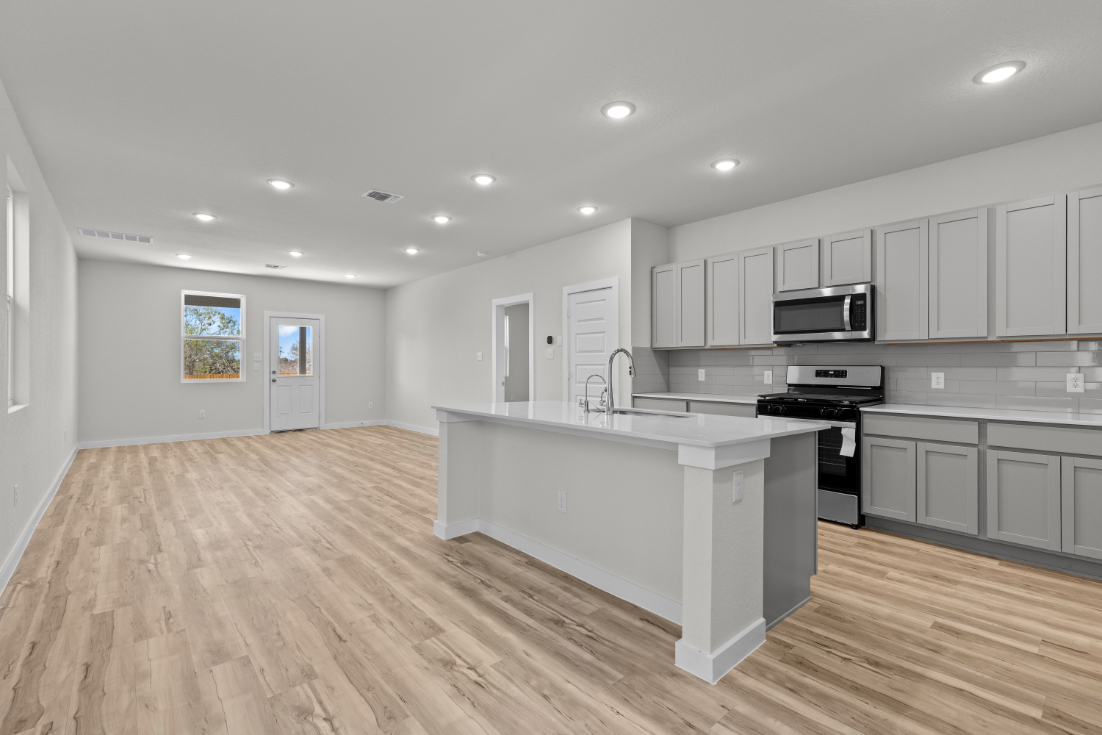 A kitchen with white cabinets.
