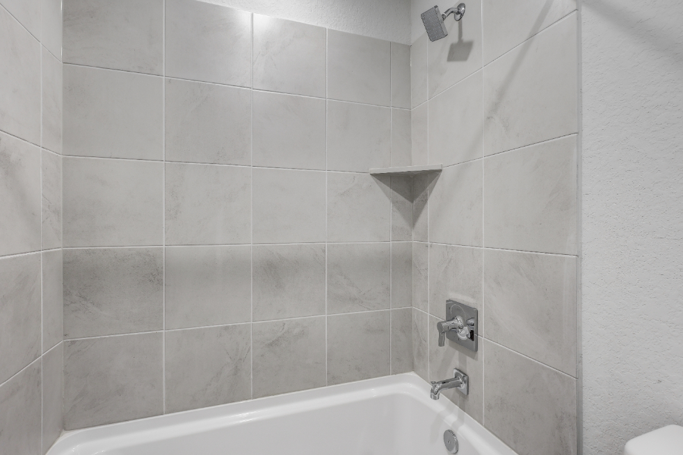 A bathroom with a bathtub and toilet.