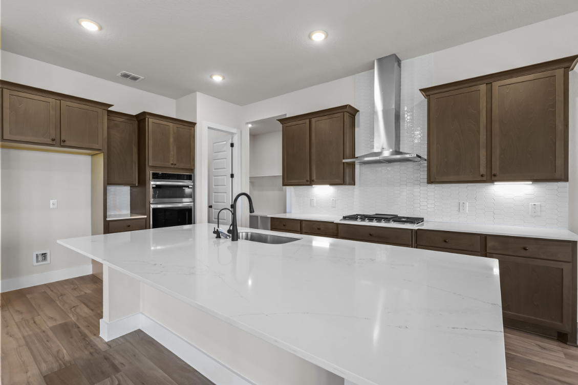 A kitchen with wooden cabinets.