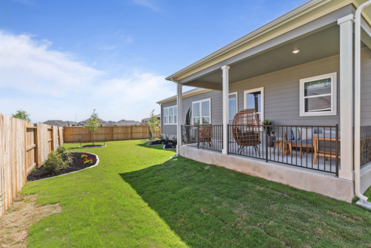A house with a lawn and chairs.