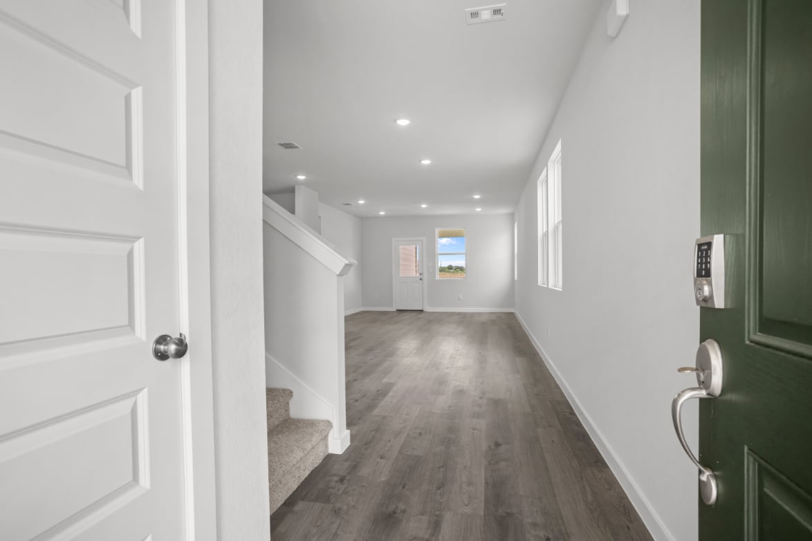 A hallway with green doors.