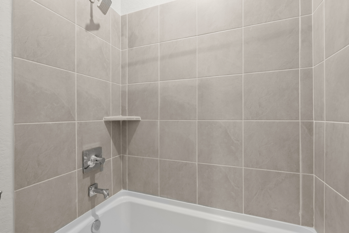 A white tiled bathroom.