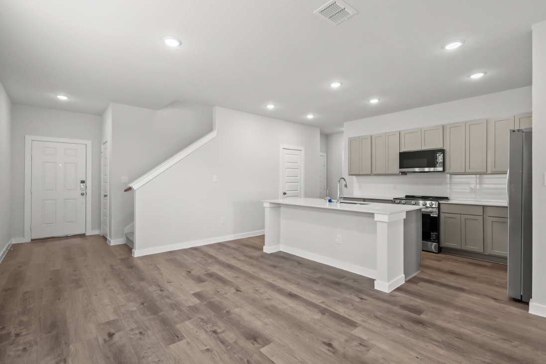 A kitchen with white cabinets.